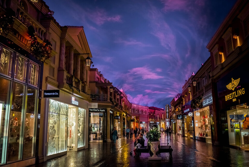 Luxe winkelstraat 's avonds laat verlicht.