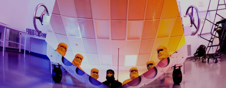 A futurist manufacturing centre with men wearing masks looking into a reflective surface