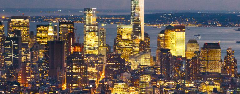 City skyline at night with lights.