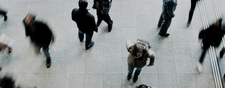Top down view of people walking in an open area.